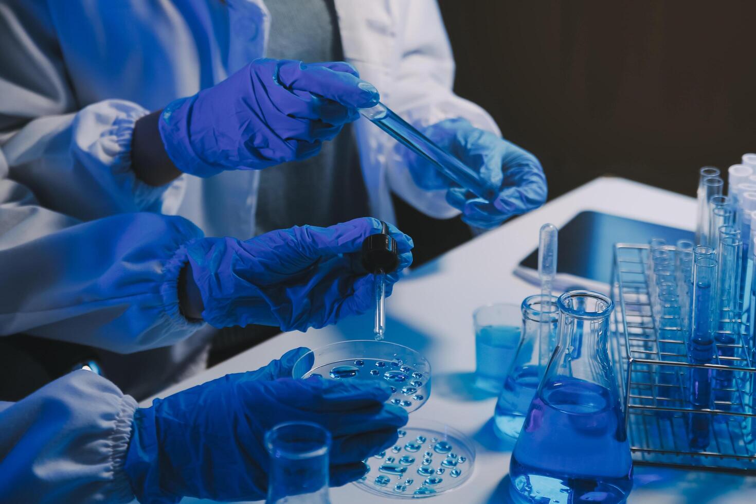 chemist,scientist hand dropping chemical liquid into test tube, science research and development concept photo