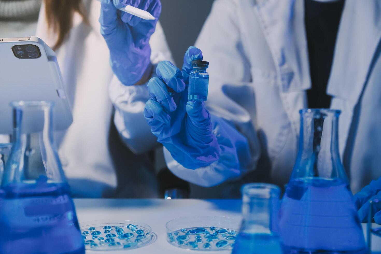 chemist,scientist hand dropping chemical liquid into test tube, science research and development concept photo