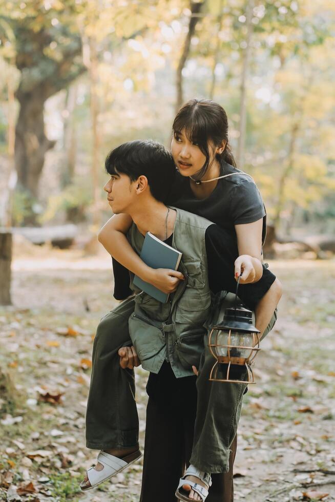 Asian couple sweet in tent inside on they camping trip, traveller relax and sleep togather in out door and camping trip photo