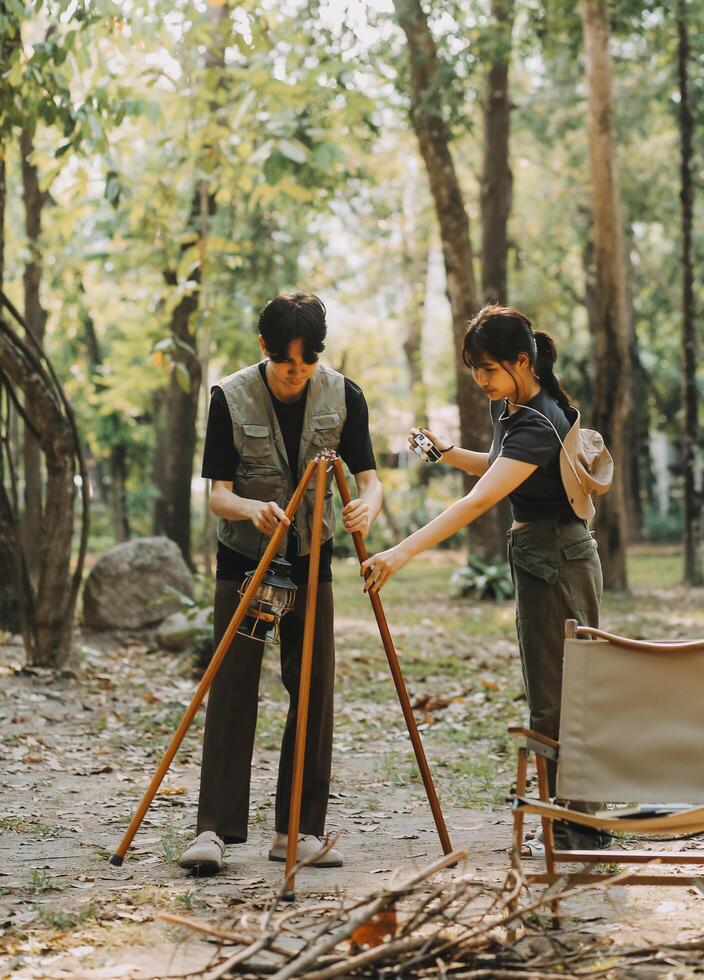 Asian couple sweet in tent inside on they camping trip, traveller relax and sleep togather in out door and camping trip photo