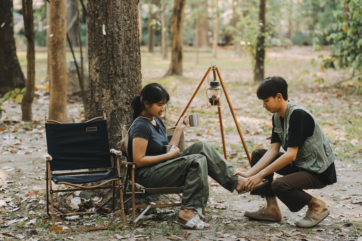 Asian couple sweet in tent inside on they camping trip, traveller relax and sleep togather in out door and camping trip photo