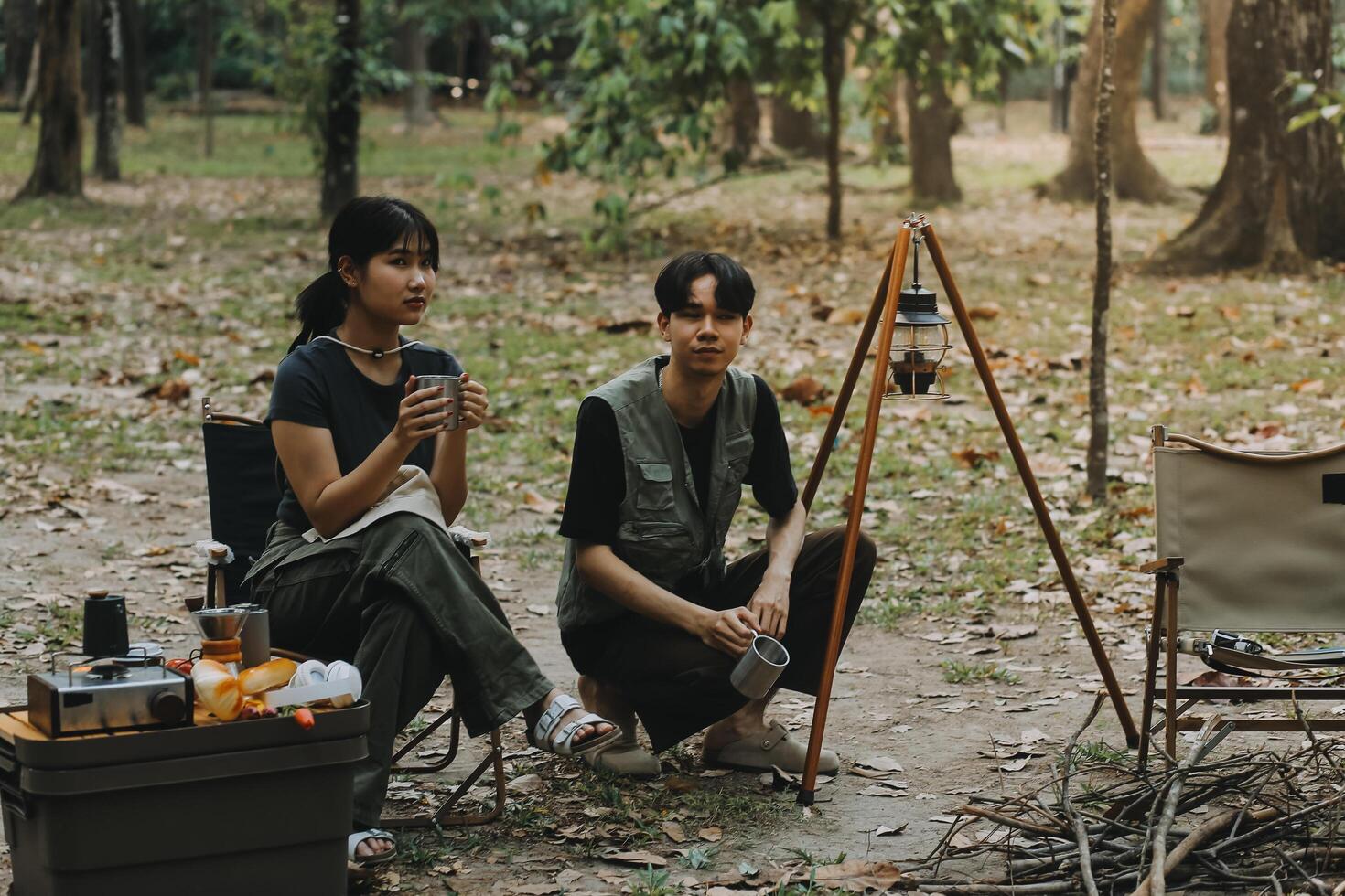 Asian couple sweet in tent inside on they camping trip, traveller relax and sleep togather in out door and camping trip photo