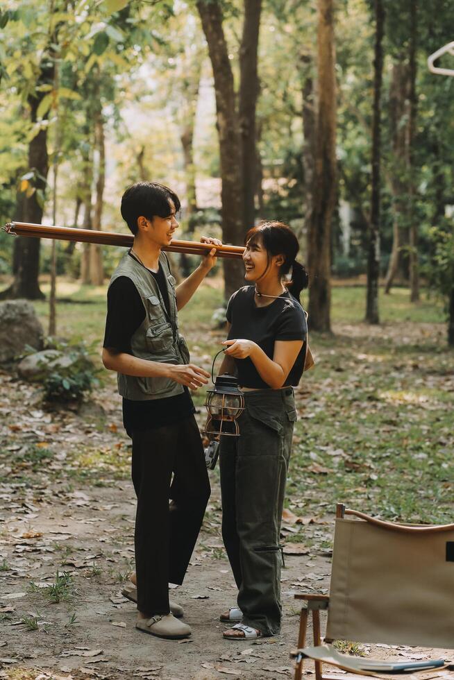 Asian couple sweet in tent inside on they camping trip, traveller relax and sleep togather in out door and camping trip photo
