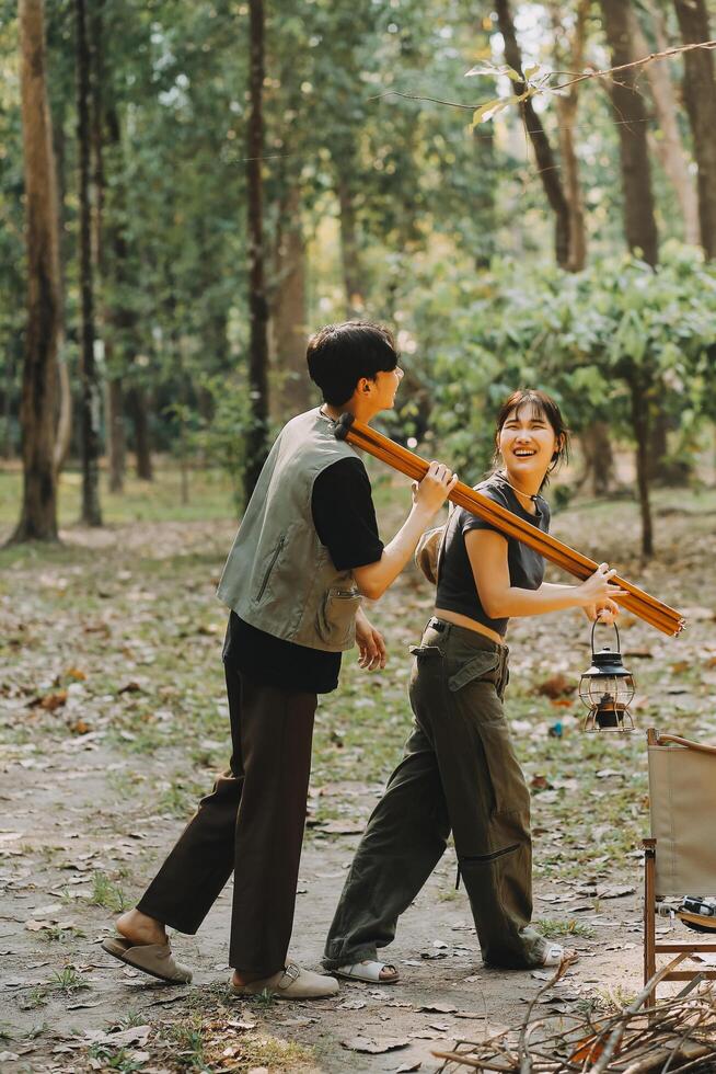 Asian couple sweet in tent inside on they camping trip, traveller relax and sleep togather in out door and camping trip photo