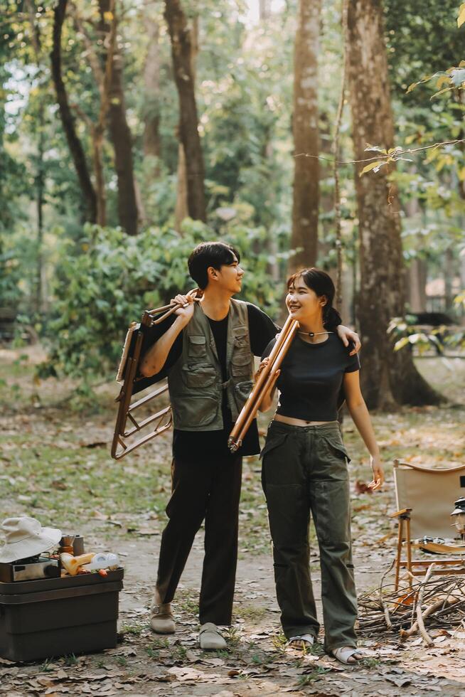 Asian couple sweet in tent inside on they camping trip, traveller relax and sleep togather in out door and camping trip photo
