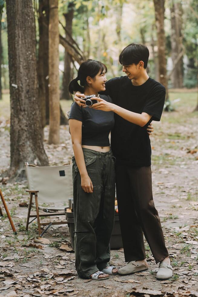 Asian couple sweet in tent inside on they camping trip, traveller relax and sleep togather in out door and camping trip photo