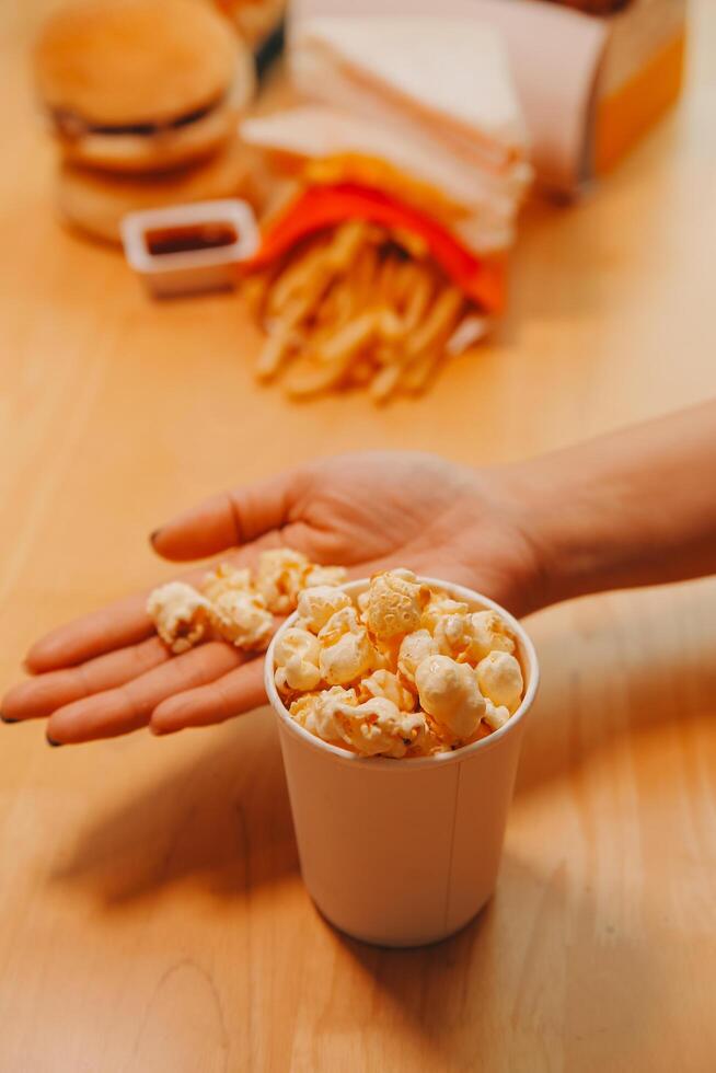 A woman holding a bowl of popcorn photo
