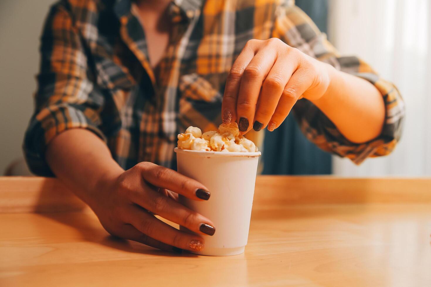 A woman holding a bowl of popcorn photo