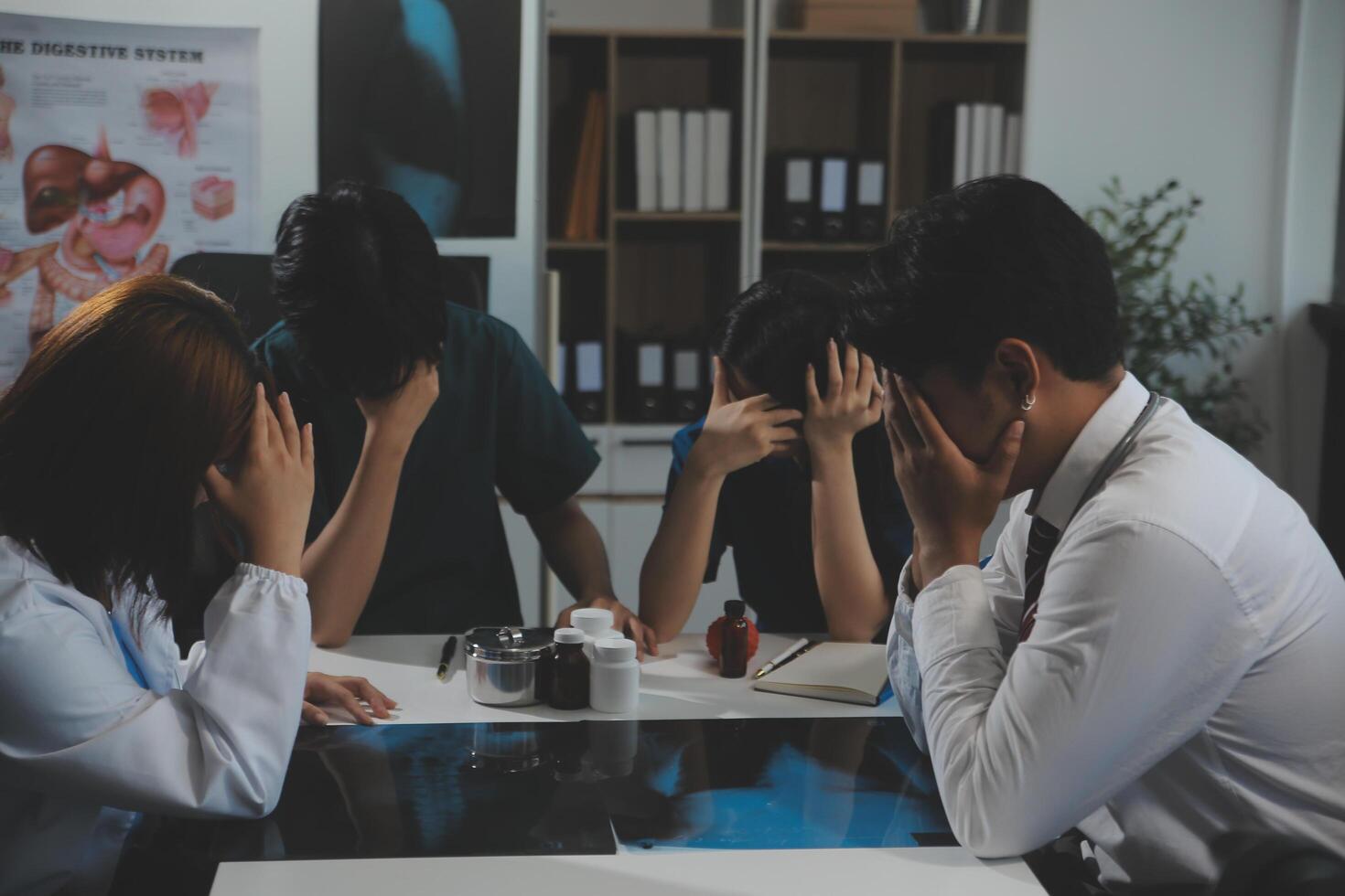 Manager Man Checking Pie Chart Data of Monthly Audit Report and Give a Negative News to his Medical Team in Hospital Boardroom Office or Healthcare Centre Meeting Room photo
