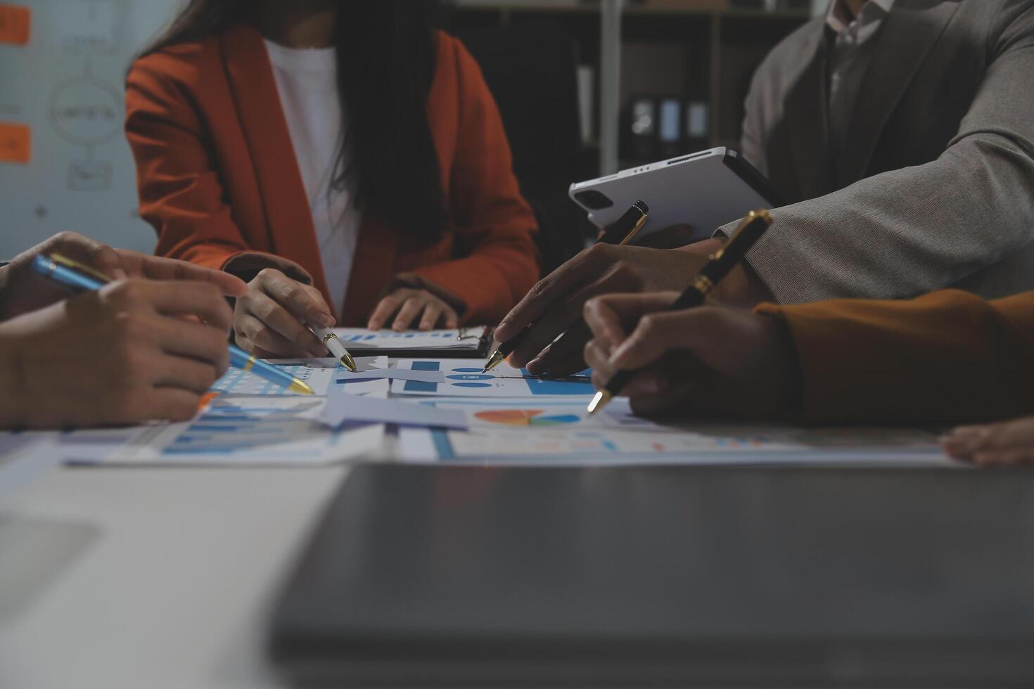 Business team collaboration discussing working analyzing with financial data and marketing growth report graph in team, presentation and brainstorming to strategy planning making profit of company. photo