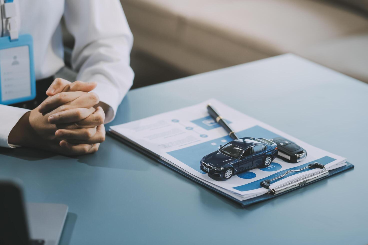 Business car rental company service, Close up hand of agent dealer giving, holding car key to customer renter, new owner after signed rental, purchase contract in document, vehicle sales agreement. photo