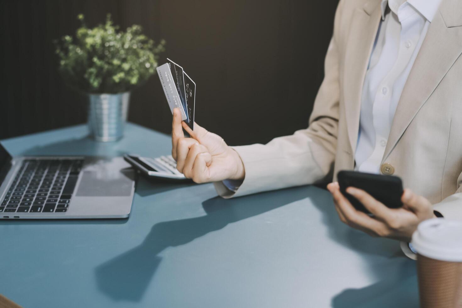 Asian woman holding credit card and using laptop computer for shopping online in website at home, e-commerce, internet banking, Technology and money transfer. Shopping and online payment concept. photo