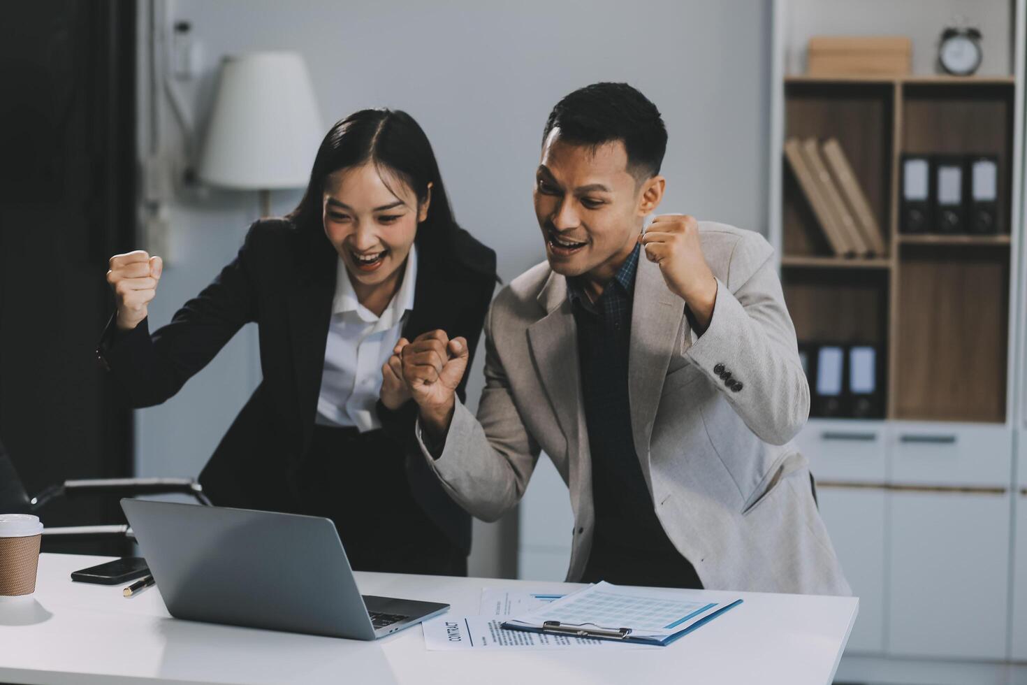 Two happy friendly diverse professionals, teacher and student giving high five standing in office celebrating success, good cooperation result, partnership teamwork and team motivation in office work. photo