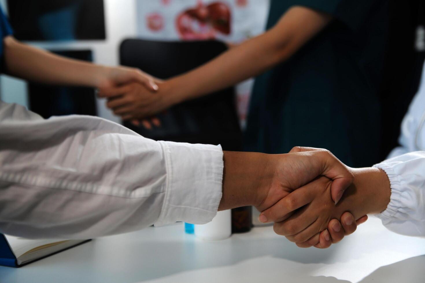 Doctor handshake and partnership in healthcare, medicine or trust for collaboration, unity or support.Team of medical experts shaking hands in teamwork for or success in hospital photo