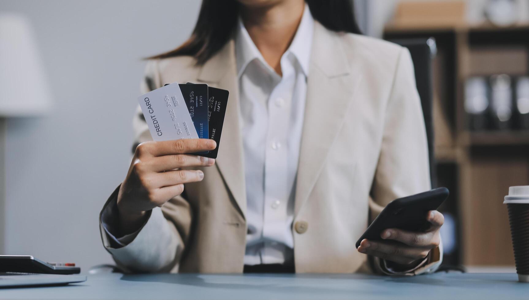 Asian woman holding credit card and using laptop computer for shopping online in website at home, e-commerce, internet banking, Technology and money transfer. Shopping and online payment concept. photo
