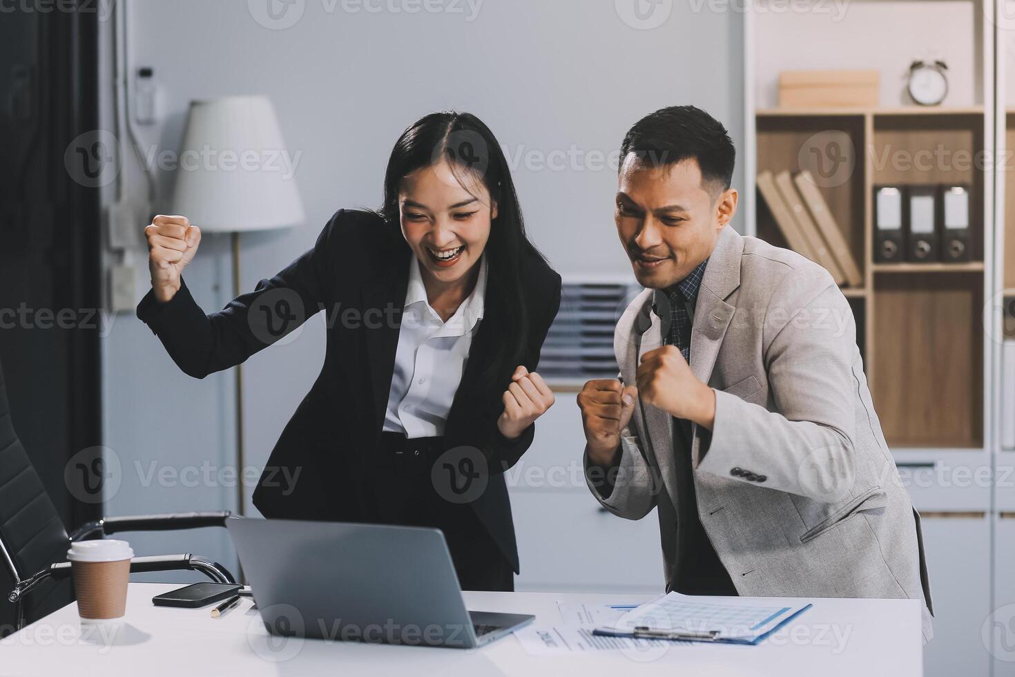 Two happy friendly diverse professionals, teacher and student giving high five standing in office celebrating success, good cooperation result, partnership teamwork and team motivation in office work. photo