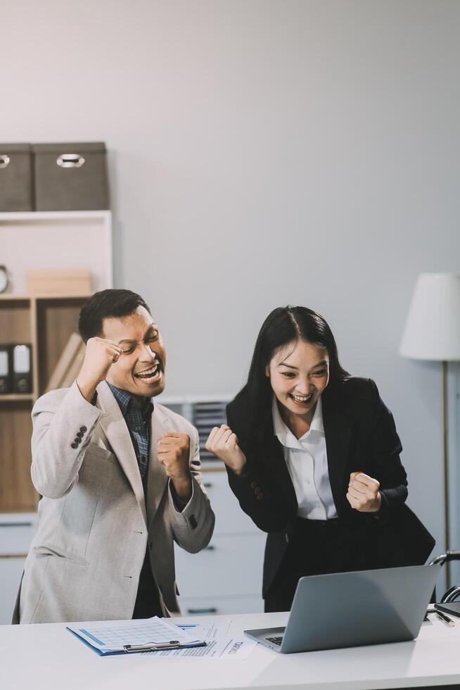 Two happy friendly diverse professionals, teacher and student giving high five standing in office celebrating success, good cooperation result, partnership teamwork and team motivation in office work. photo