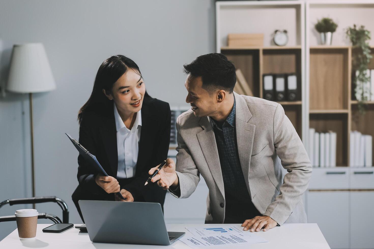Two happy friendly diverse professionals, teacher and student giving high five standing in office celebrating success, good cooperation result, partnership teamwork and team motivation in office work. photo