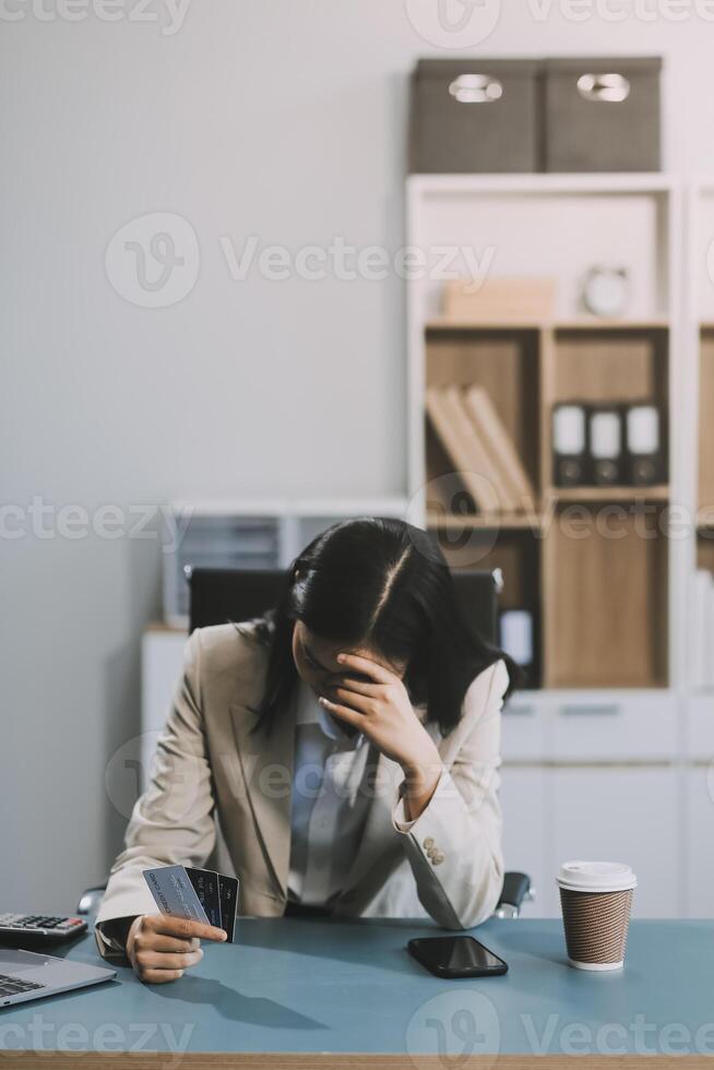 Asian woman holding credit card and using laptop computer for shopping online in website at home, e-commerce, internet banking, Technology and money transfer. Shopping and online payment concept. photo