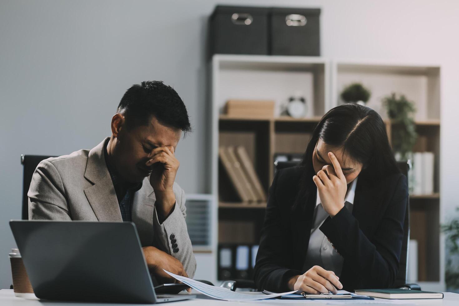 Manager is hard talking with employee in an office. Businessmen arguing at workplace, disagreeing over document, partners having conflict while negotiating, business deal failure photo