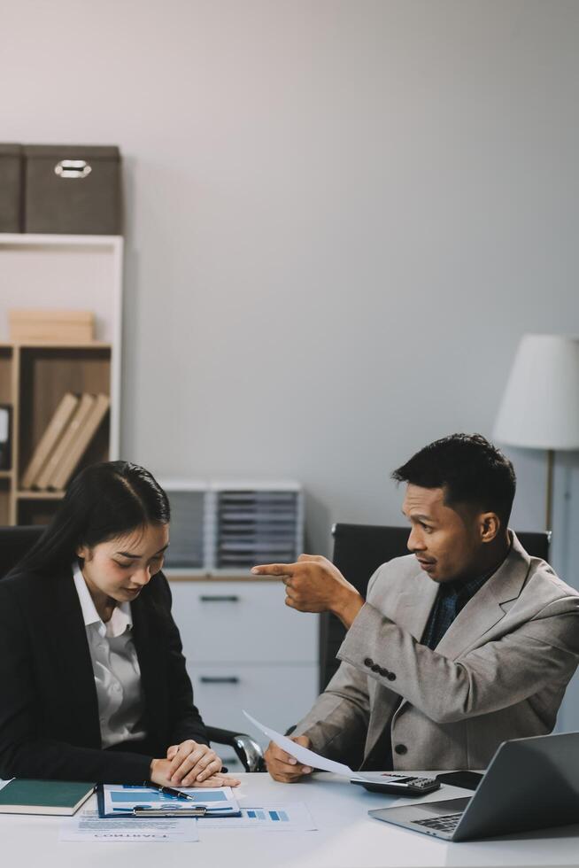 Manager is hard talking with employee in an office. Businessmen arguing at workplace, disagreeing over document, partners having conflict while negotiating, business deal failure photo