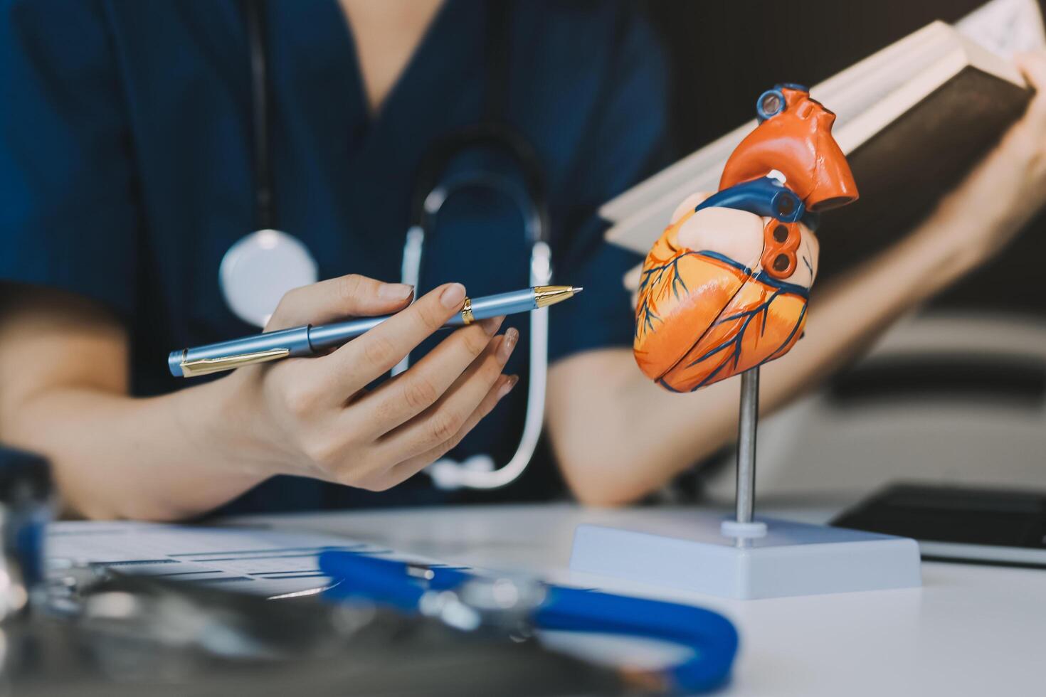 Portrait of young female doctor cardiologist working in office of modern clinic photo