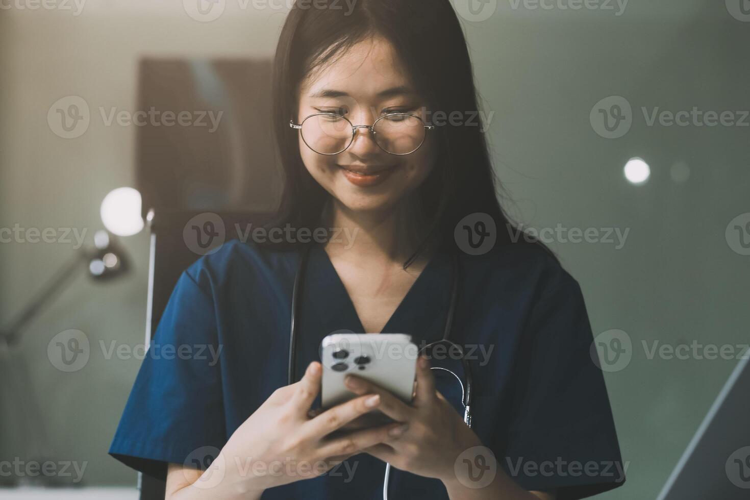 Professional doctor working at office desk, he is using a smartphone, healthcare and technology concept photo