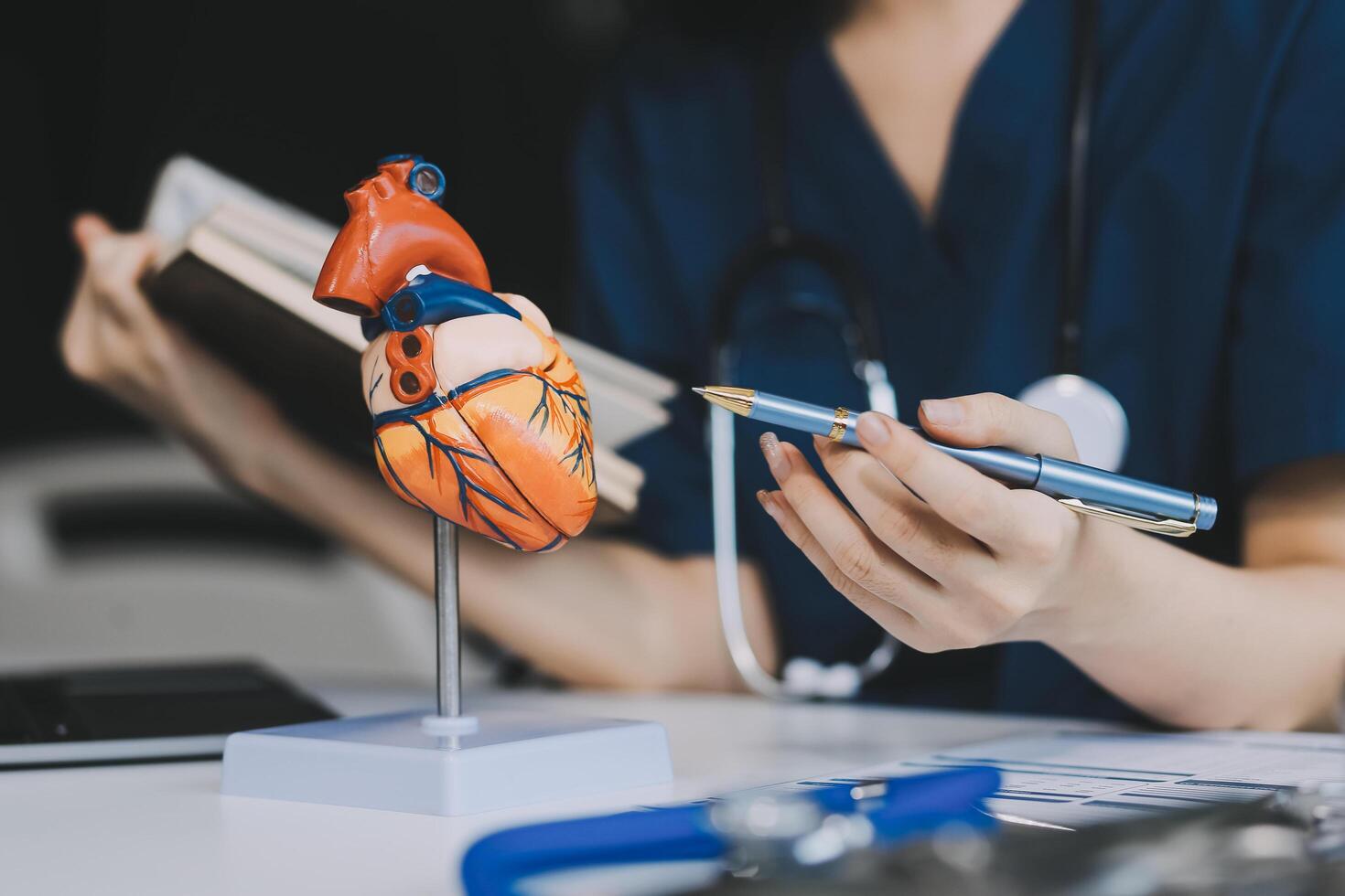 Portrait of young female doctor cardiologist working in office of modern clinic photo