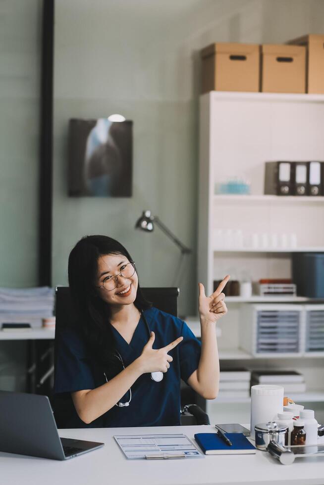 Portrait of beautiful physician doctor sit on table in office hospital. Attractive therapist female practitioner pharmacist smile and looking at camera after success work from treatment in hospital. photo