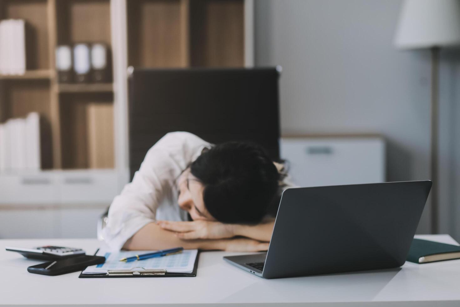 Asian women are stressed while working on laptop, Tired asian businesswoman with headache at office, feeling sick at work, copy space photo