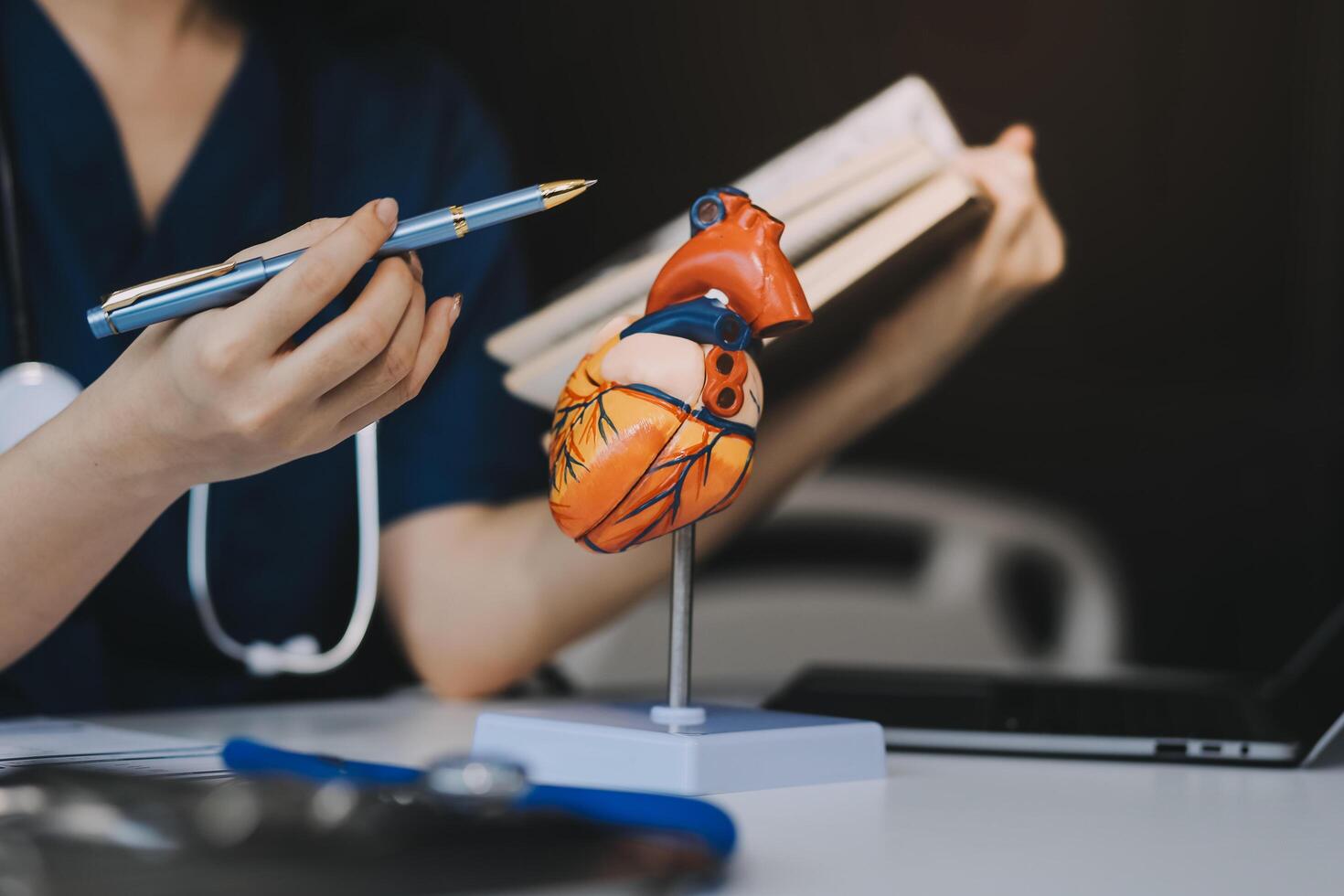 Portrait of young female doctor cardiologist working in office of modern clinic photo