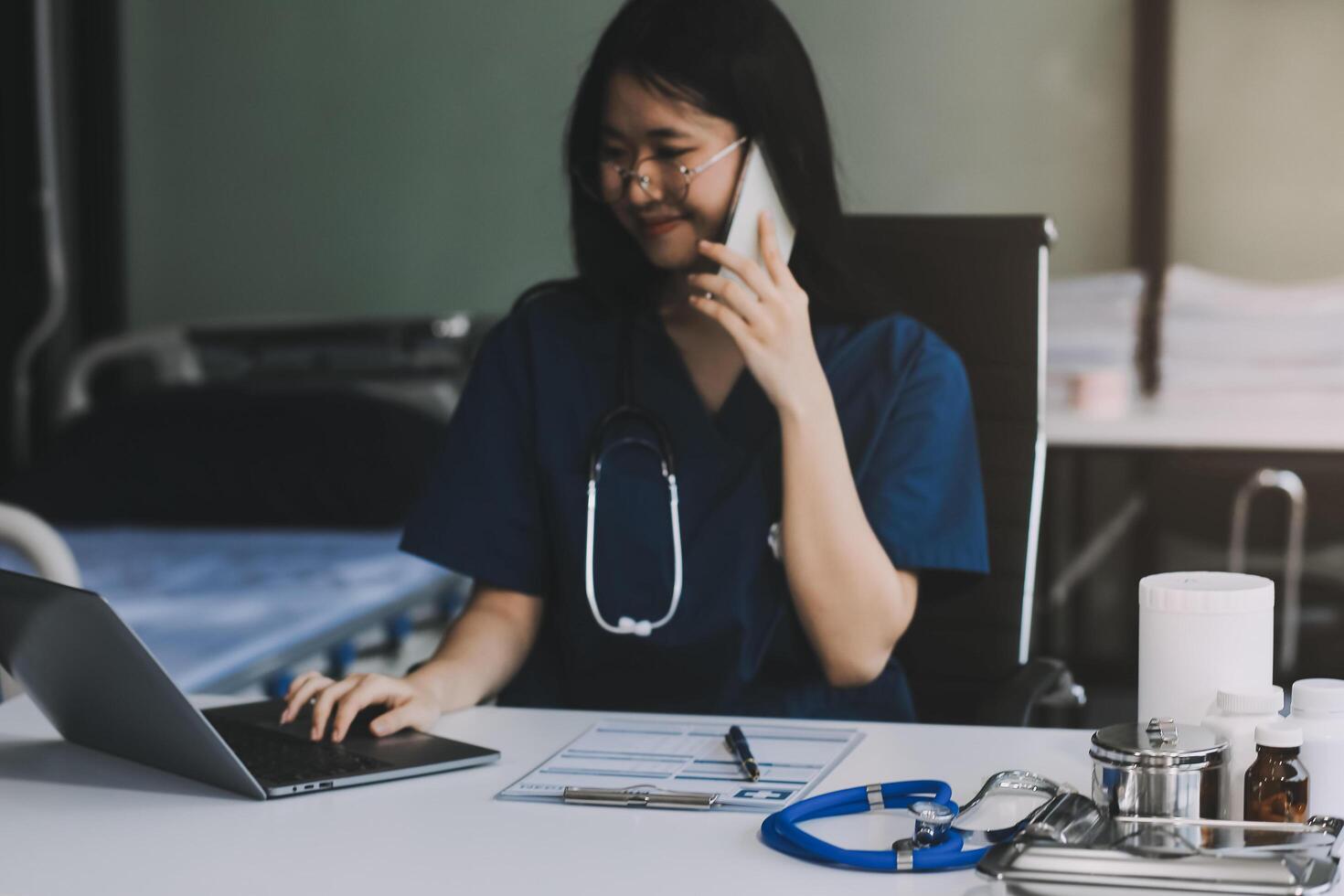 Professional doctor working at office desk, he is using a smartphone, healthcare and technology concept photo