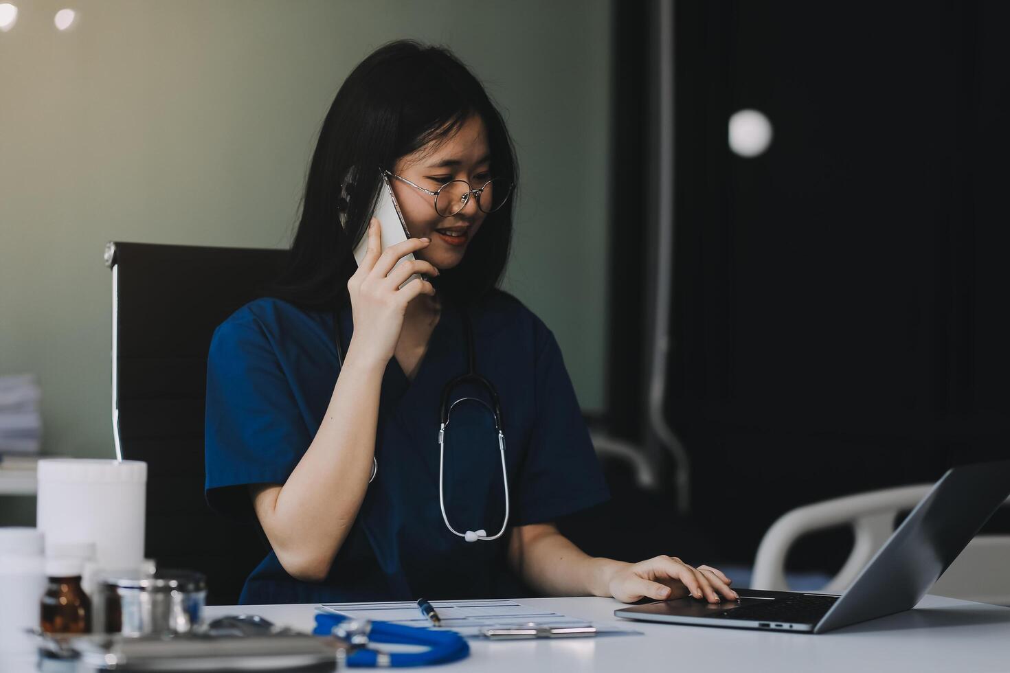 Professional doctor working at office desk, he is using a smartphone, healthcare and technology concept photo