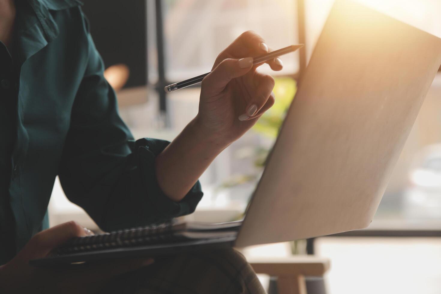 Distracted from work worried young woman sitting on couch with laptop, thinking of problems. Pensive unmotivated lady looking at window, feeling lack of energy, doing remote freelance tasks at home. photo