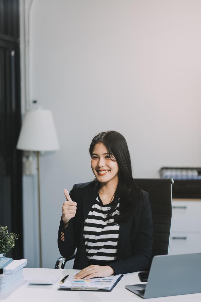 Young pretty business woman with notebook in the office photo