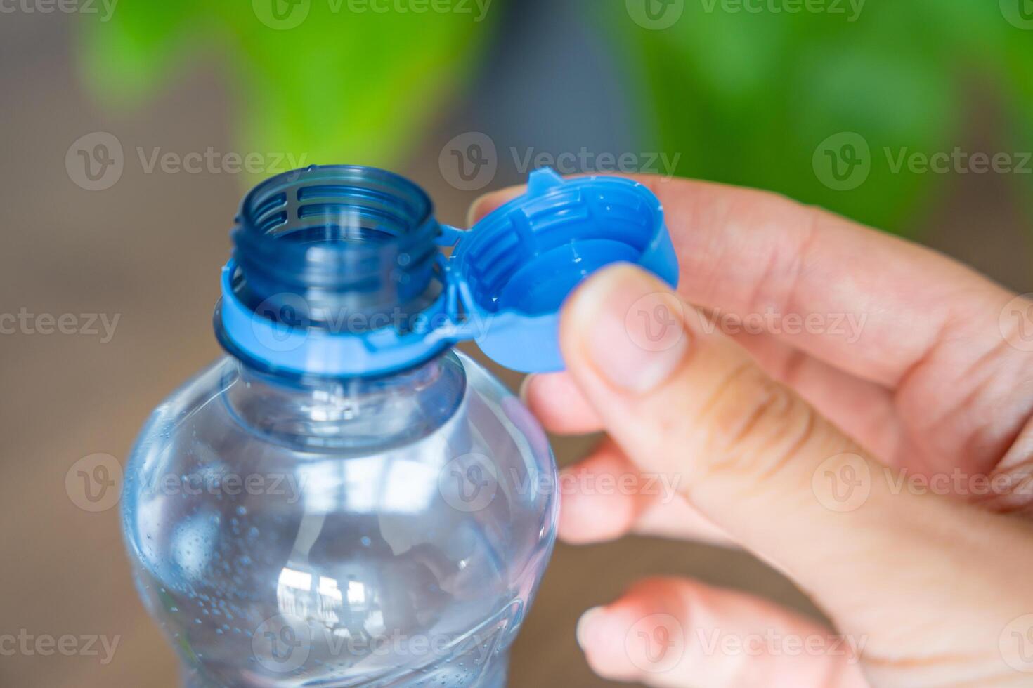 Stationary plastic cap on a PET bottle. The new design means the cap remains attached to the bottle after opening, making the entire package easier to collect and recycle. High quality photo