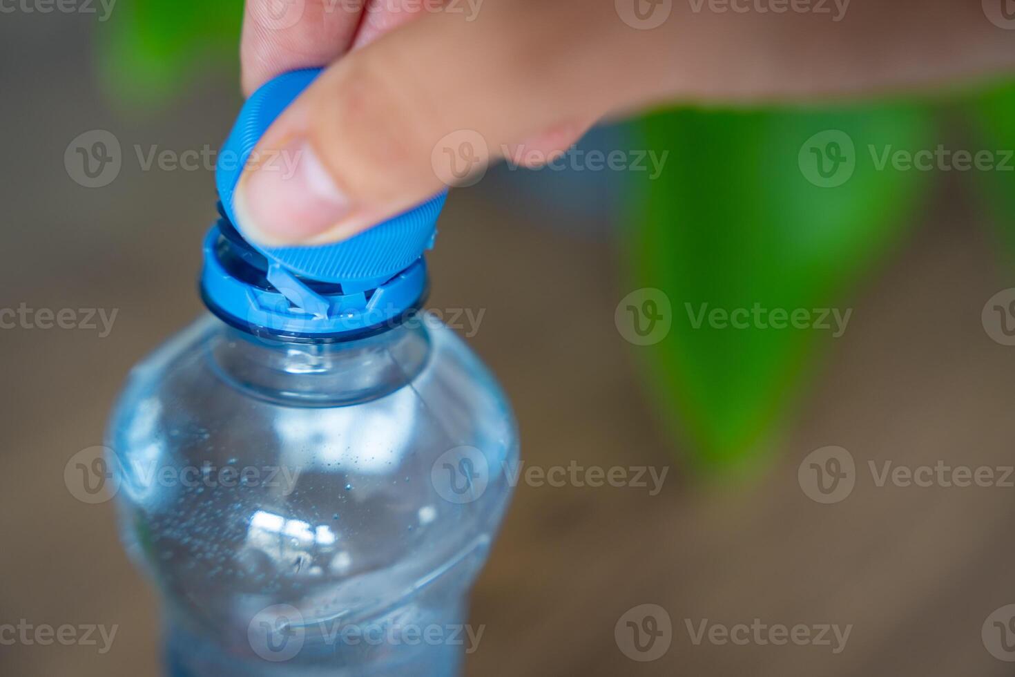 Stationary plastic cap on a PET bottle. The new design means the cap remains attached to the bottle after opening, making the entire package easier to collect and recycle. High quality photo