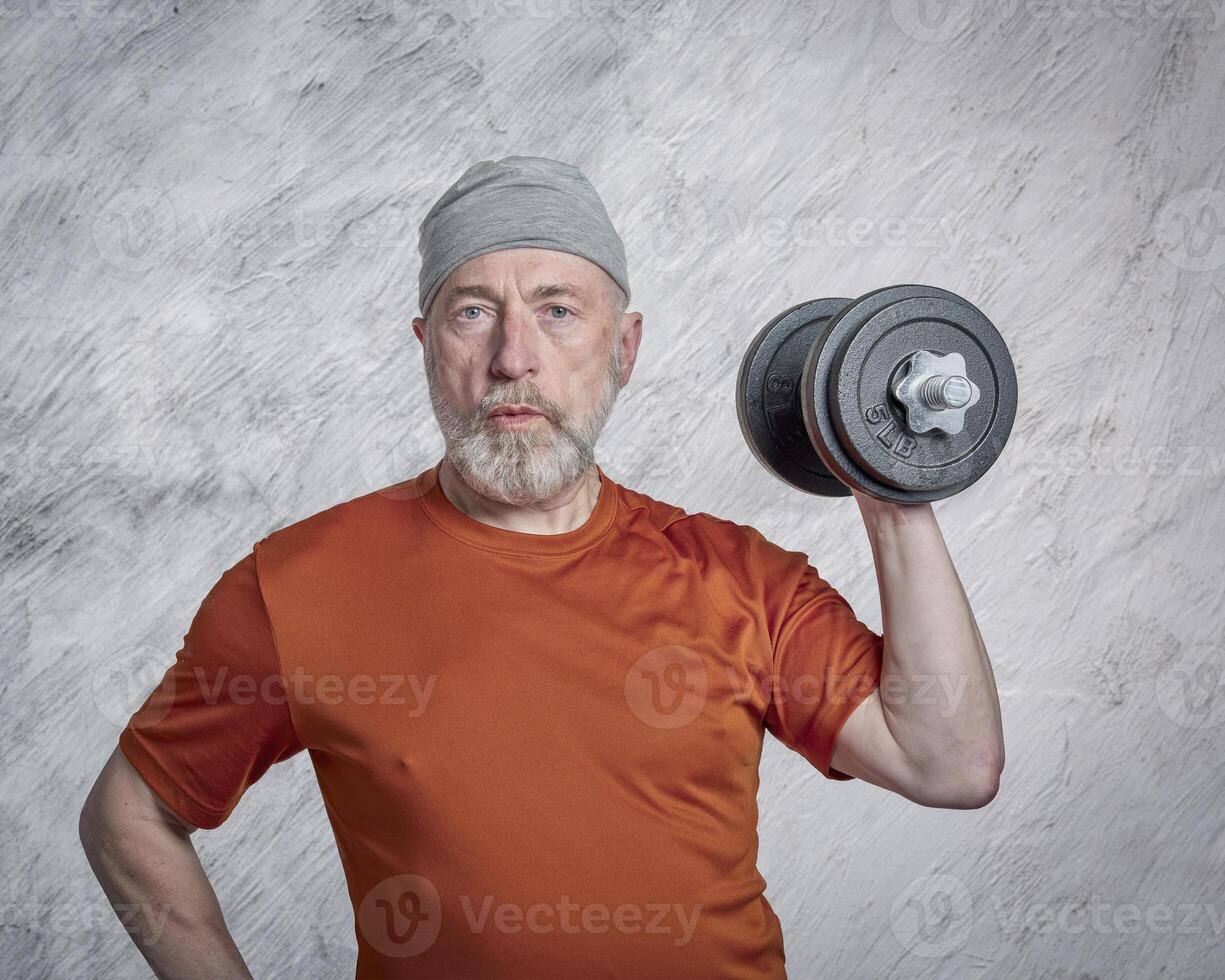senior man exercising with heavy dumbbells photo