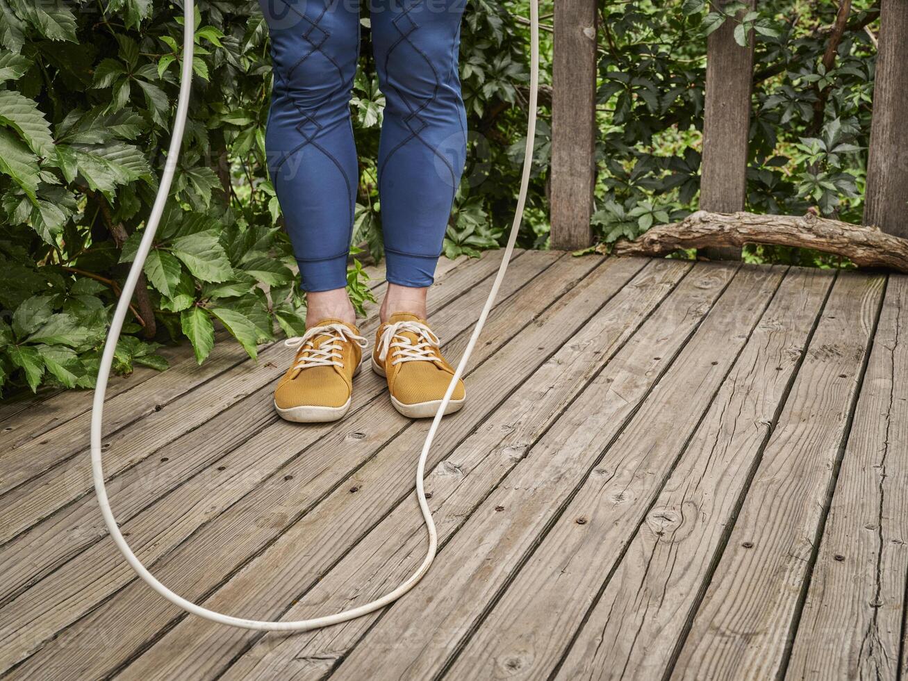 workout with a heavy jump rope in a backyard photo