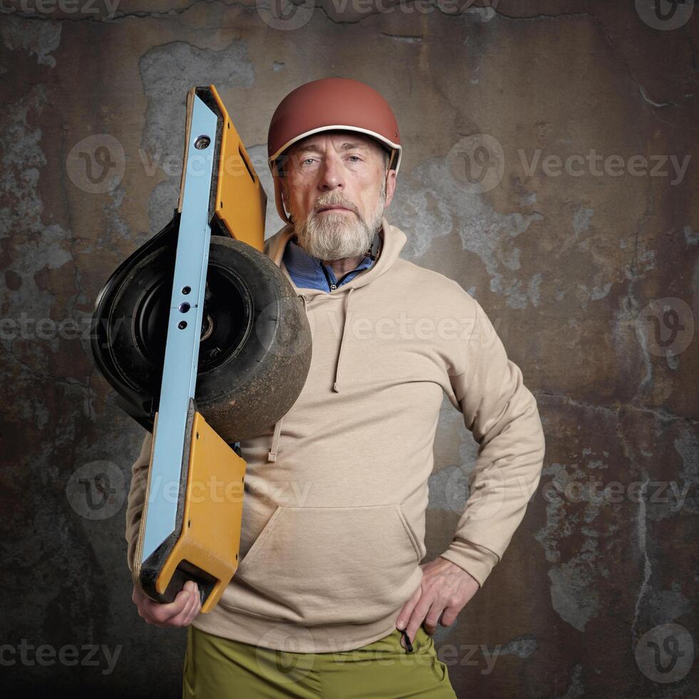 senior man with one-wheeled electric skateboard photo