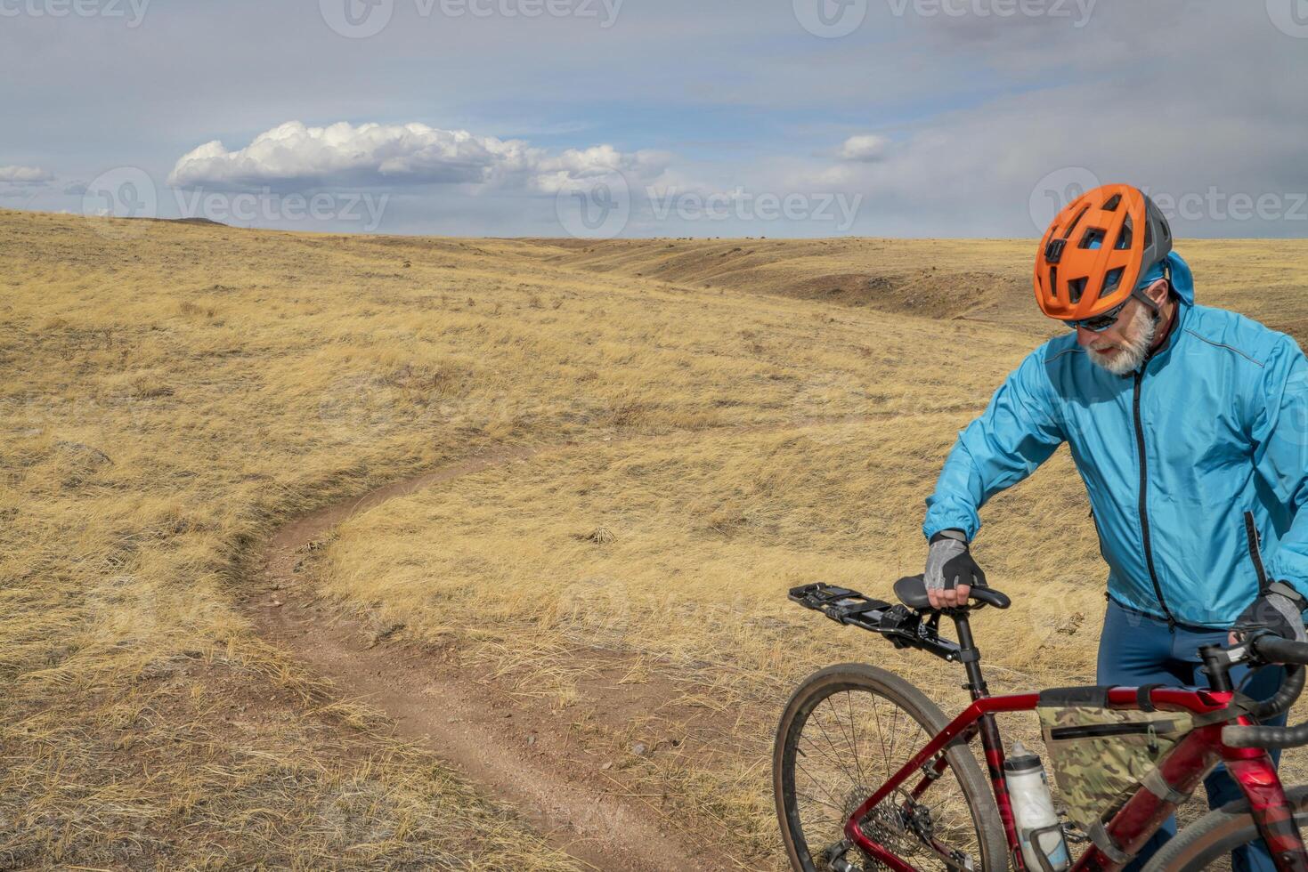 male cyclist with a gravel bike in prairie photo