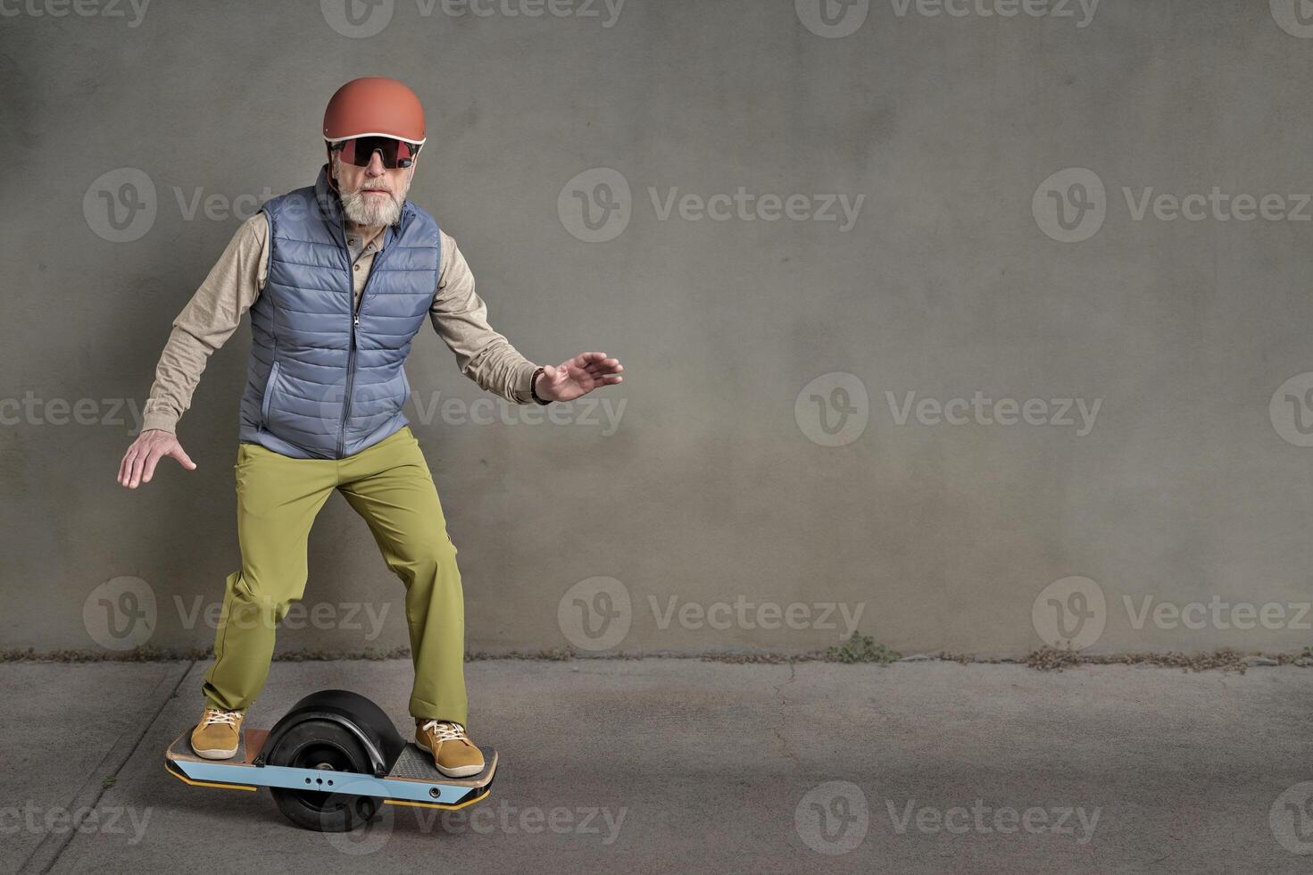 senior man riding one-wheeled electric skateboard photo