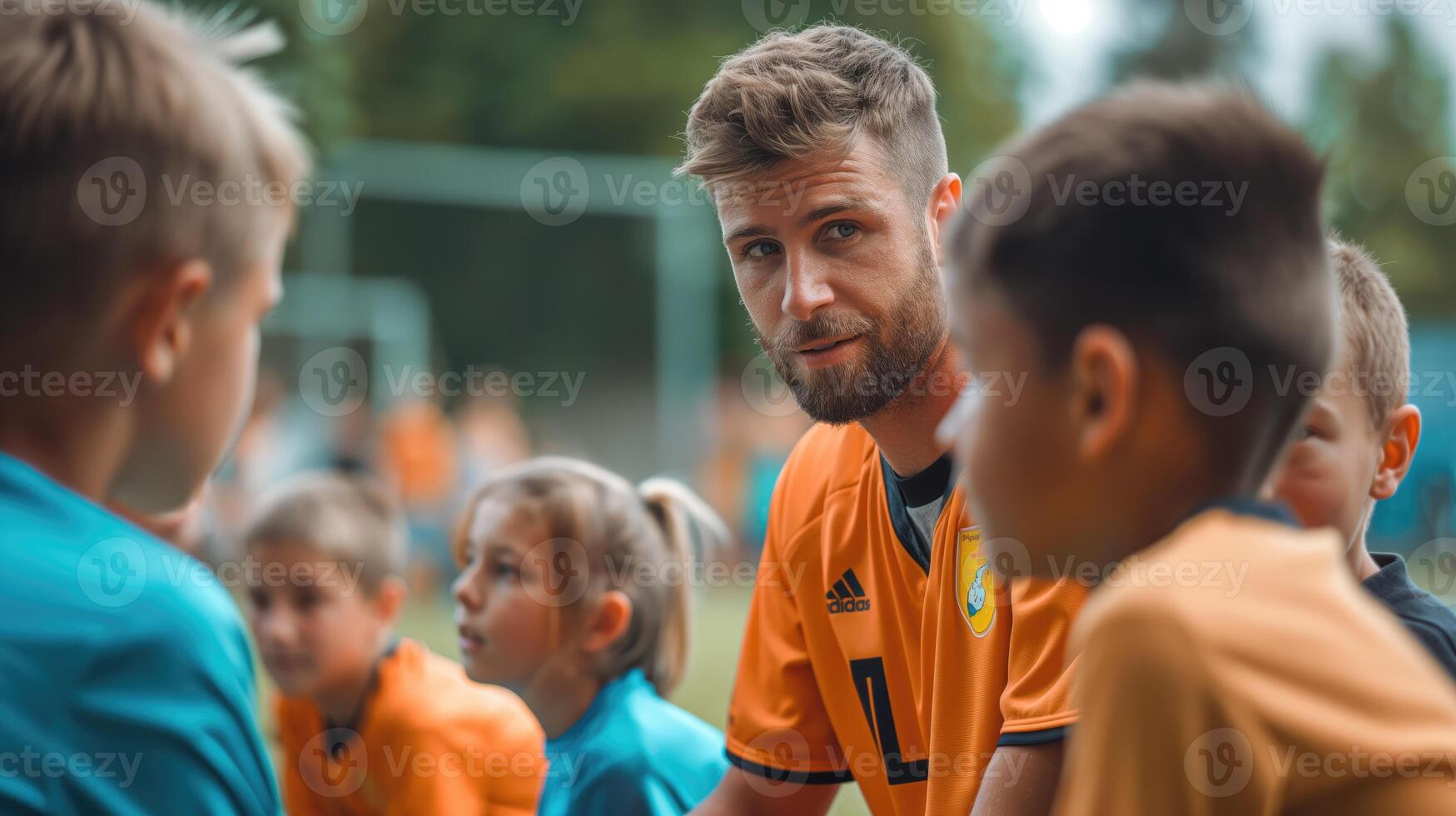 A group of kids gathered around coach, soccer. Football trainer teaching his pupils photo