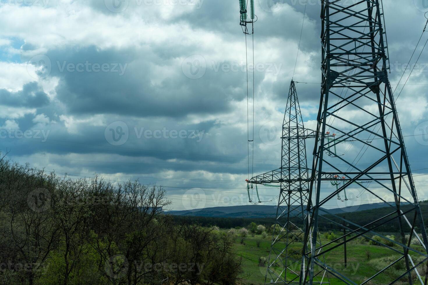 High voltage towers with sky background. Power line support with wires for electricity transmission. High voltage grid tower with wire cable at distribution station. Energy industry, energy saving photo
