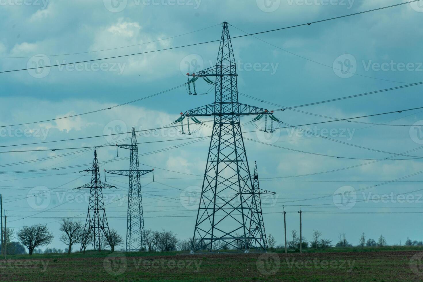 High voltage towers with sky background. Power line support with wires for electricity transmission. High voltage grid tower with wire cable at distribution station. Energy industry, energy saving photo