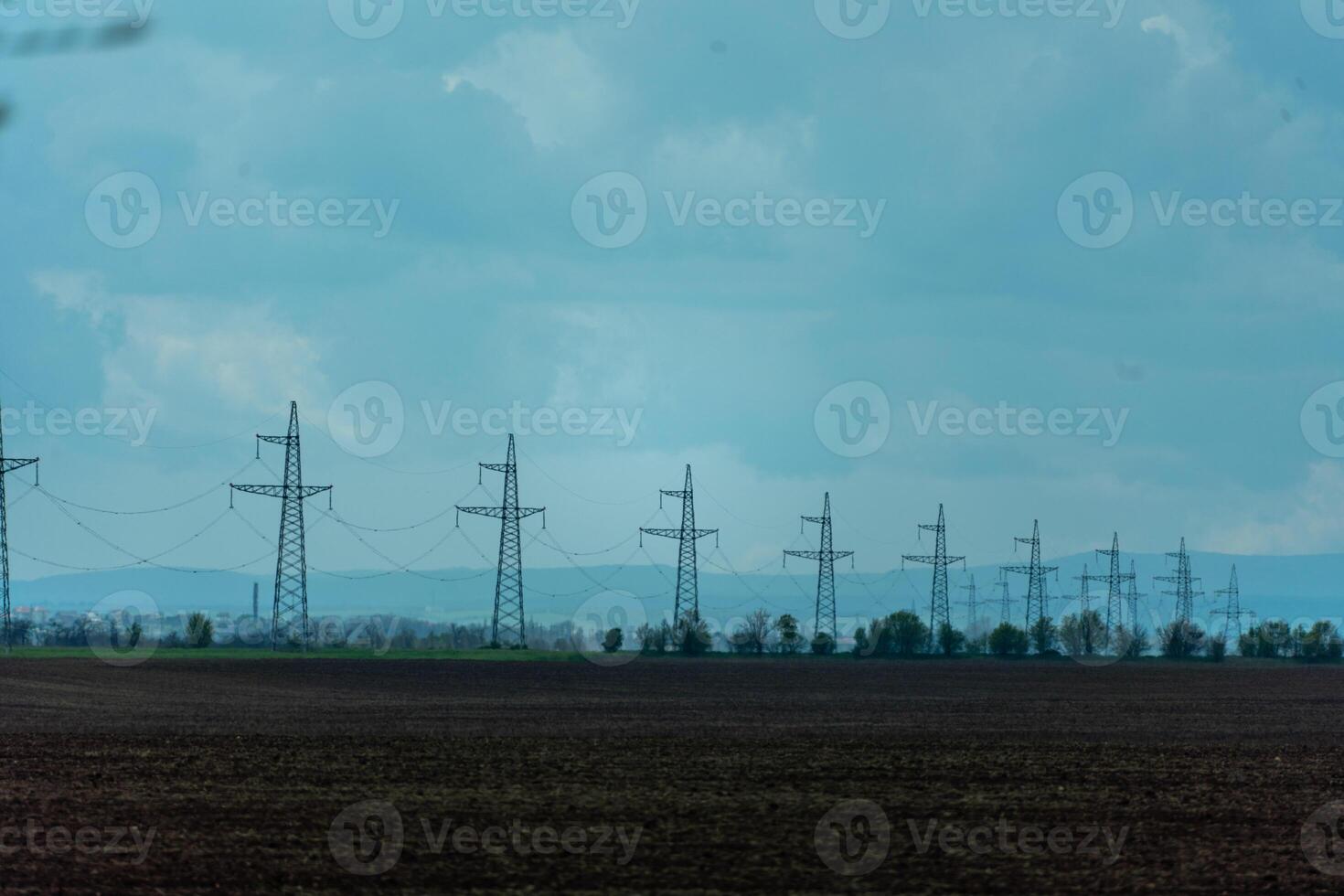 High voltage towers with sky background. Power line support with wires for electricity transmission. High voltage grid tower with wire cable at distribution station. Energy industry, energy saving photo