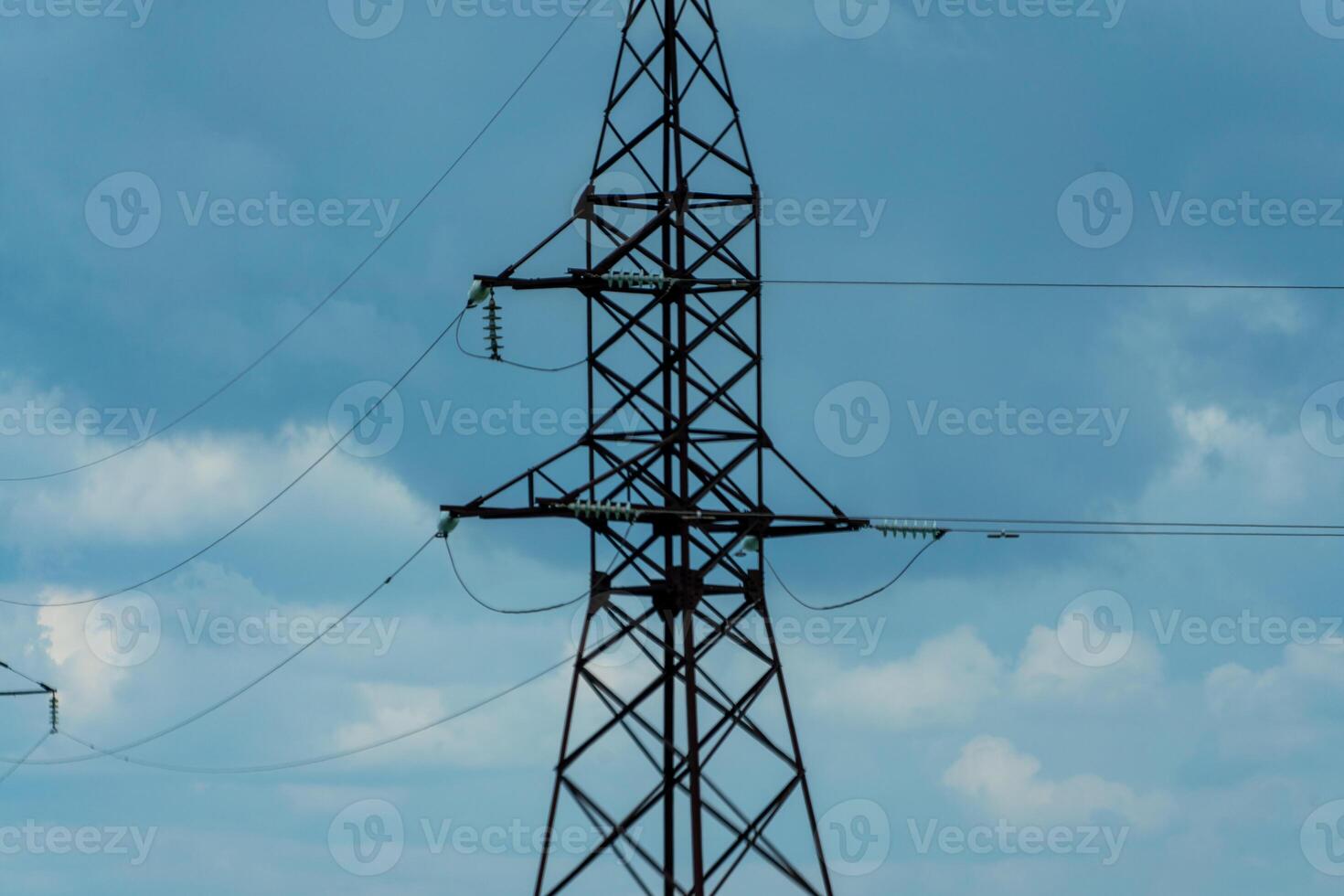 High voltage towers with sky background. Power line support with wires for electricity transmission. High voltage grid tower with wire cable at distribution station. Energy industry, energy saving photo