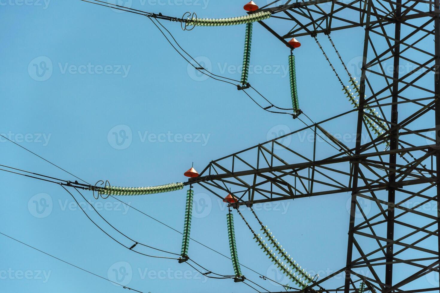 High voltage towers with sky background. Power line support with wires for electricity transmission. High voltage grid tower with wire cable at distribution station. Energy industry, energy saving photo