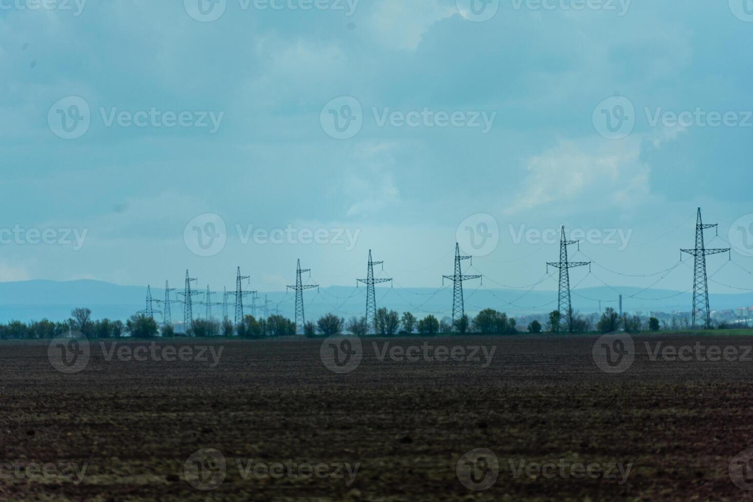 High voltage towers with sky background. Power line support with wires for electricity transmission. High voltage grid tower with wire cable at distribution station. Energy industry, energy saving photo