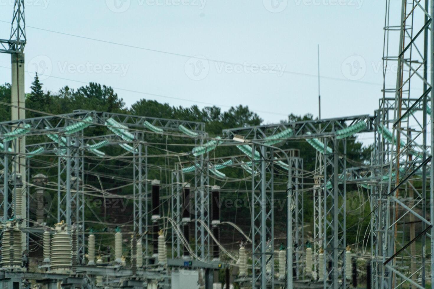 High voltage towers with sky background. Power line support with wires for electricity transmission. High voltage grid tower with wire cable at distribution station. Energy industry, energy saving photo